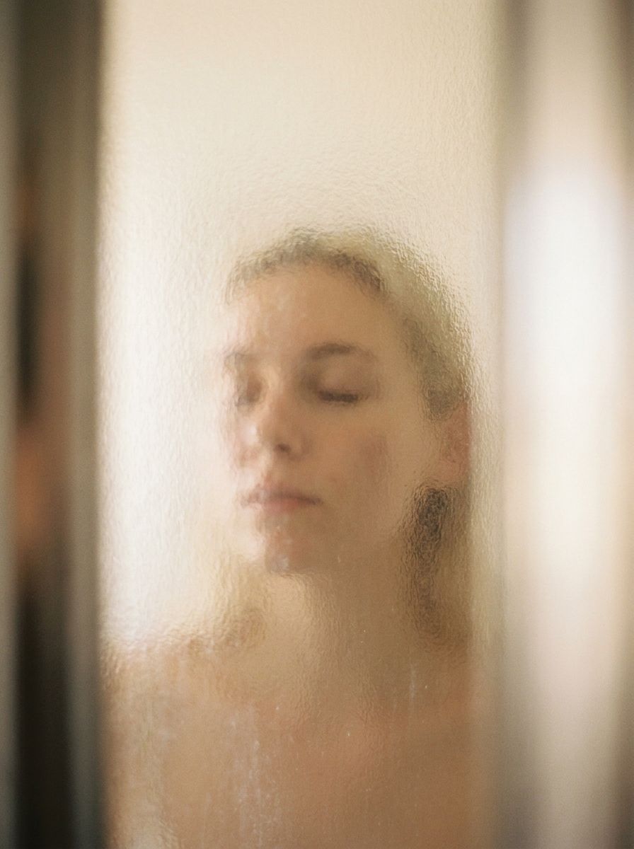 A face at rest seen through textured glass